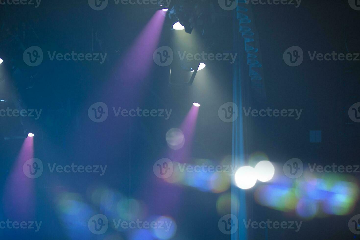 Blue concert background with pink rays and bokeh spots. photo
