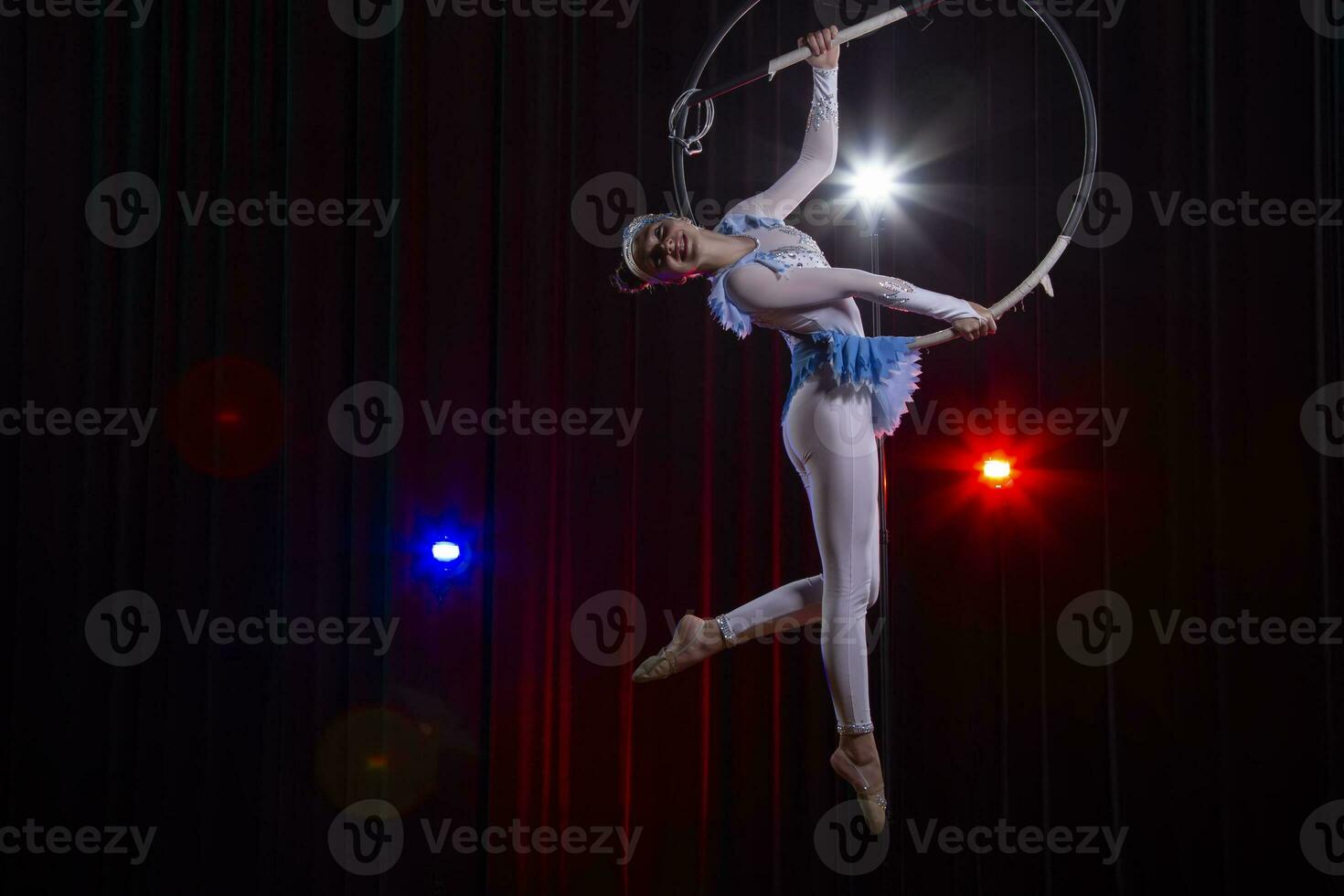 Circus acrobats gymnasts perform on a stage dark background. photo
