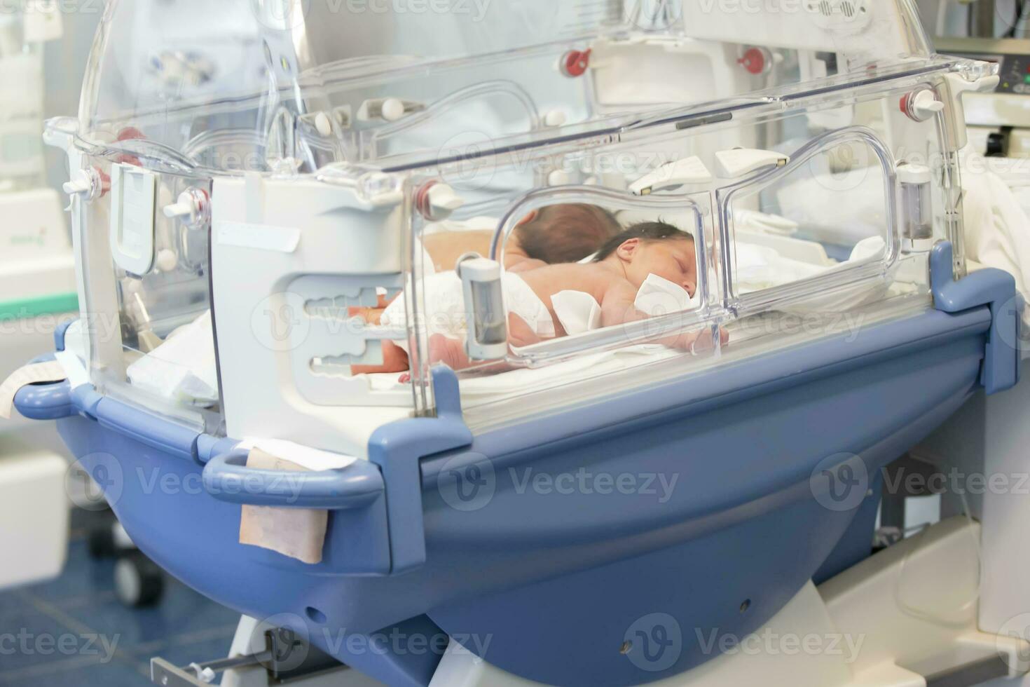 Newborn children are in the boxes in the hospital. photo