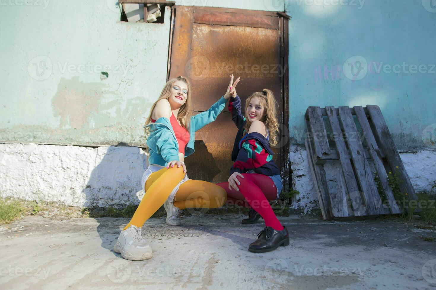 Funny girls in the style of the 90s in bright clothes. photo