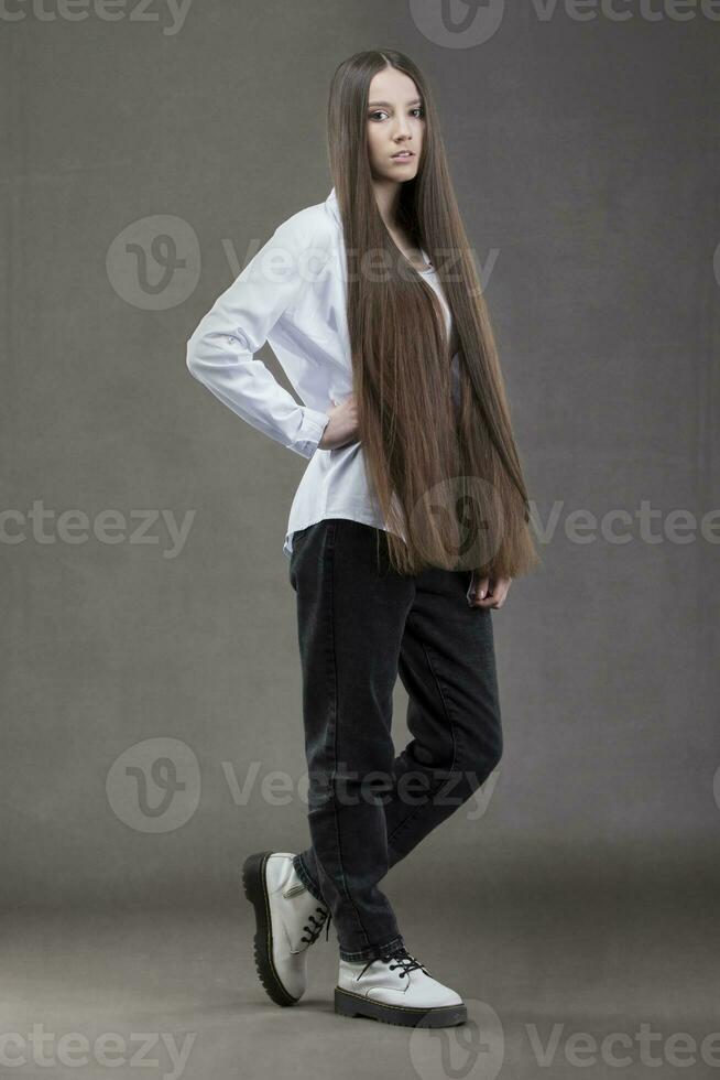 A beautiful young girl in height with long dark hair. photo