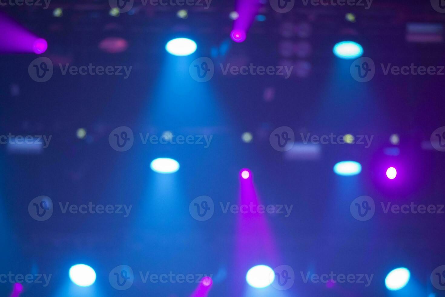 Blue stage background with white and pink projector beams. photo