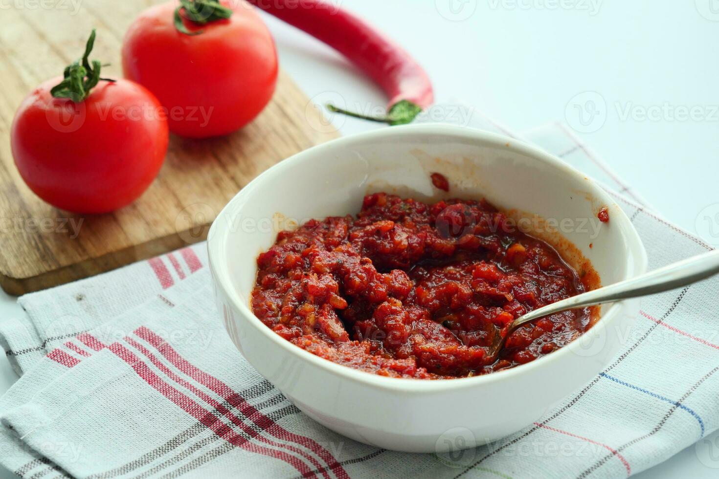 Tomato paste with ripe tomatoes. photo