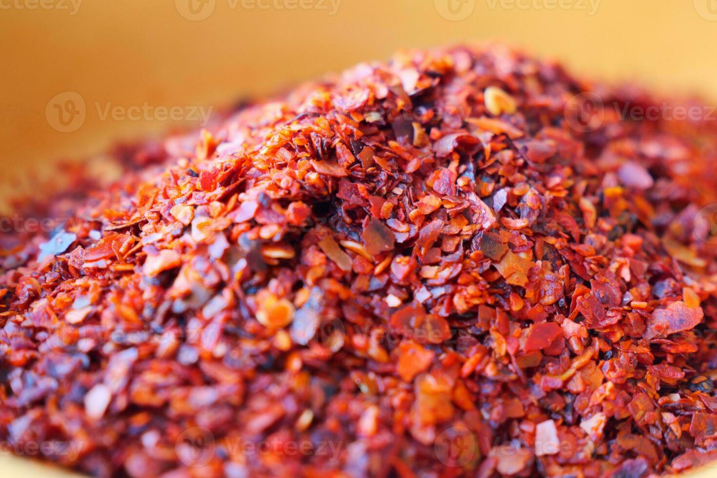 closeup of chili flakes in a bowl on table photo