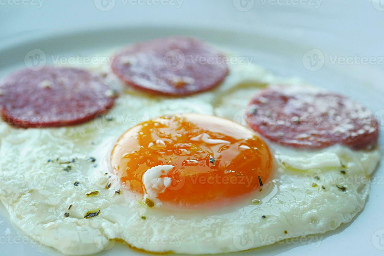 fried egg mixed with sausage on a plate photo