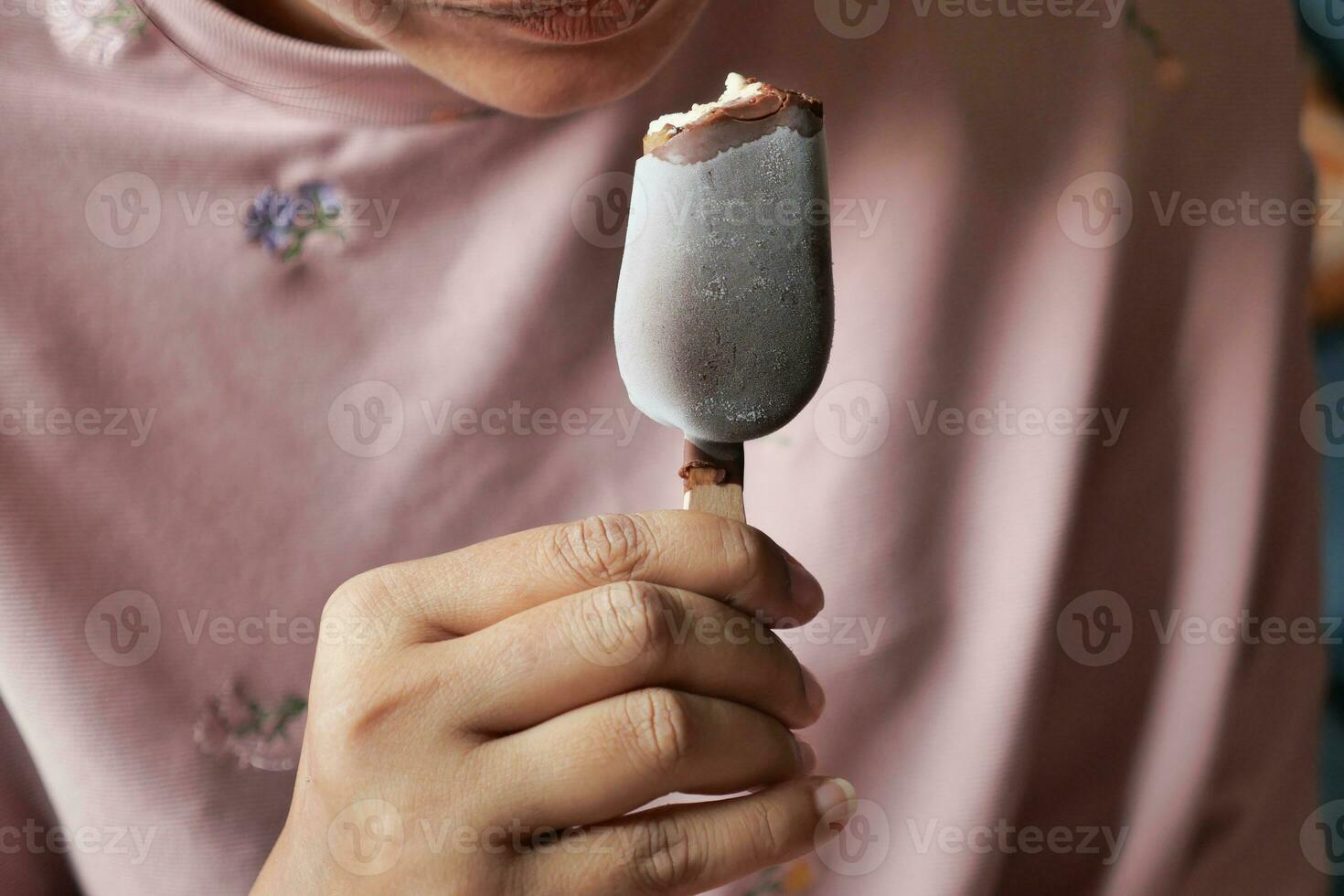 young women eating chocolate flavor ice cream photo