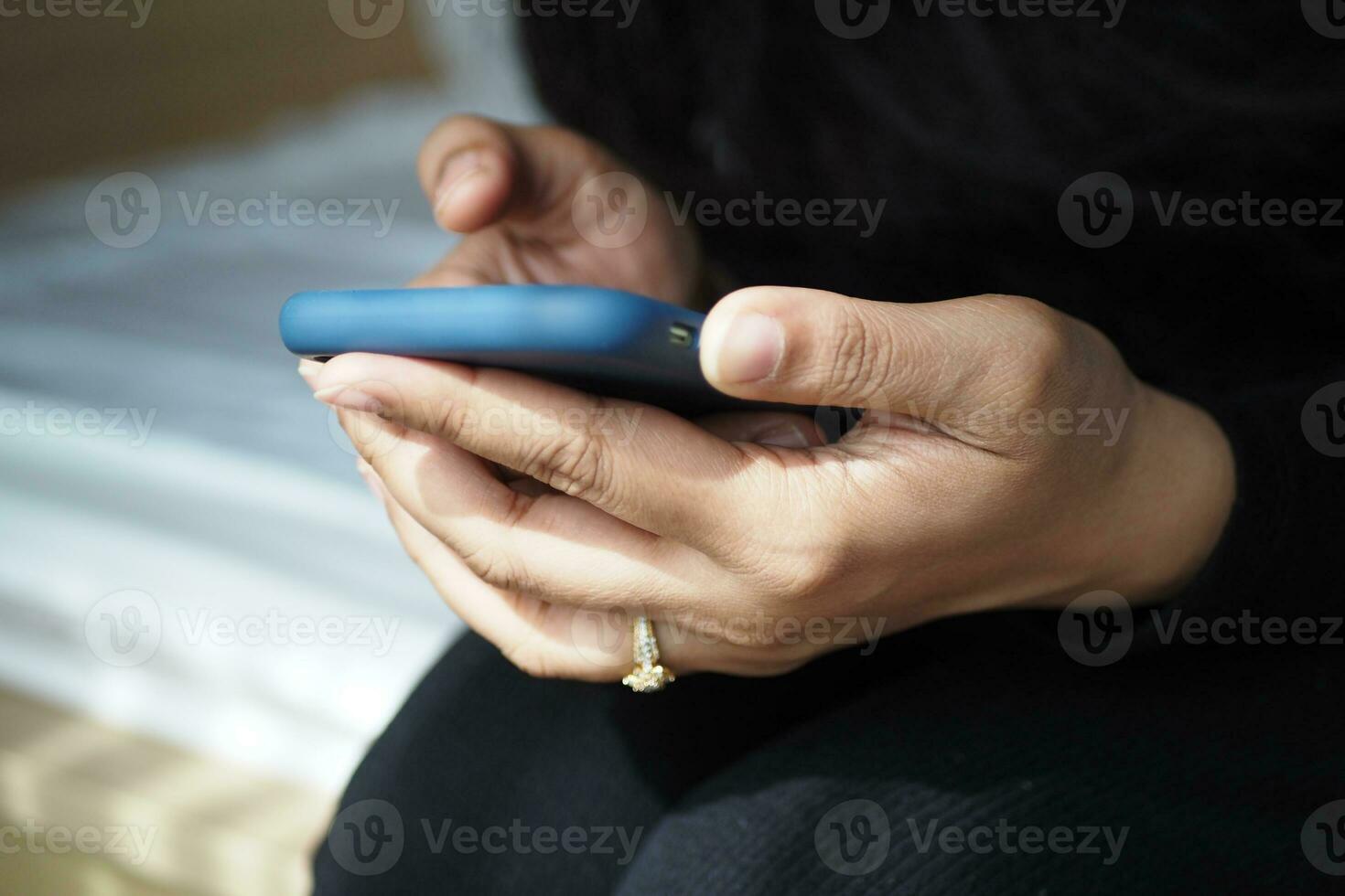 close up of women hand holding smart phone photo