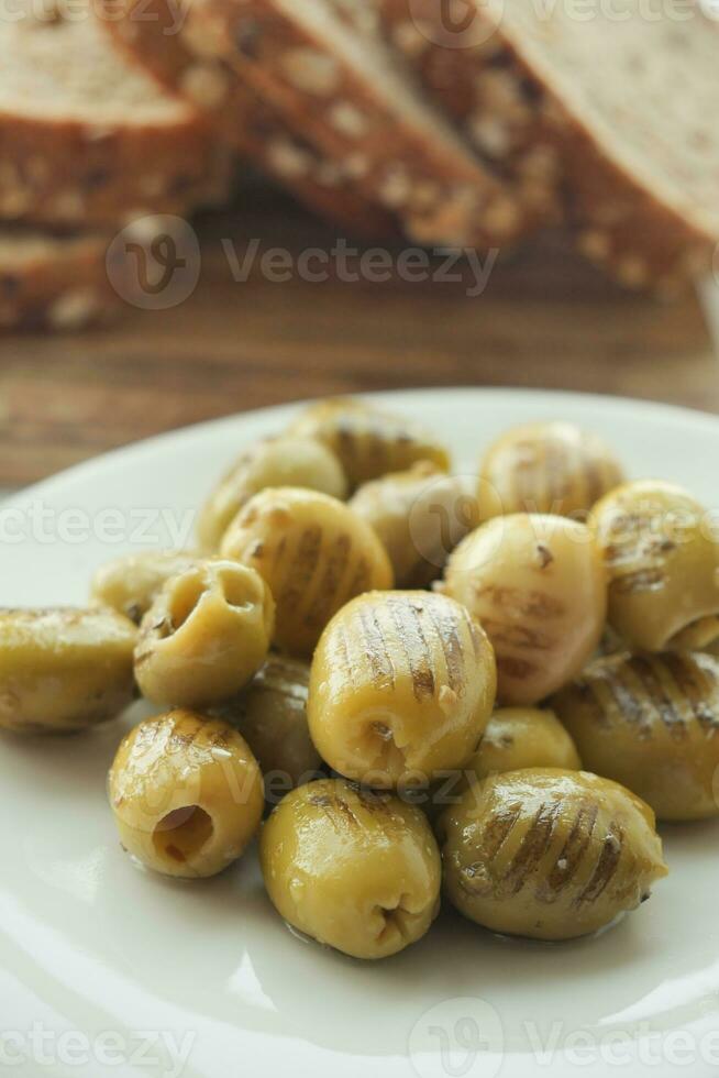Turkish Grilled olives in a bowl photo