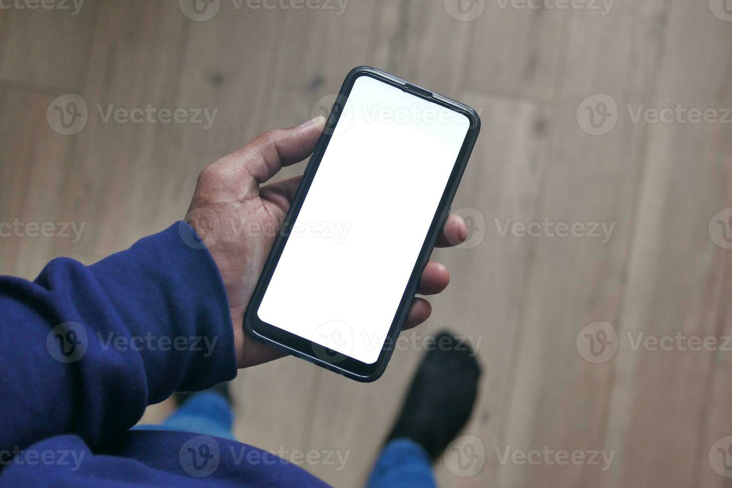 pov shot of young man hand using smart phone with white screen photo