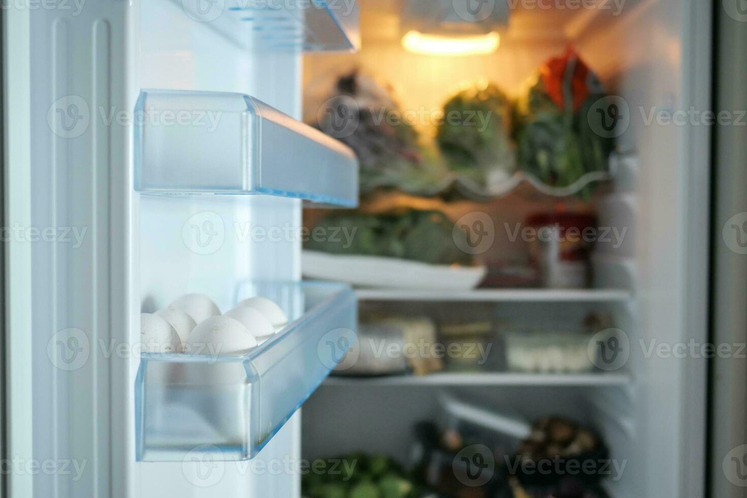 white eggs on the refrigerator shelf. photo