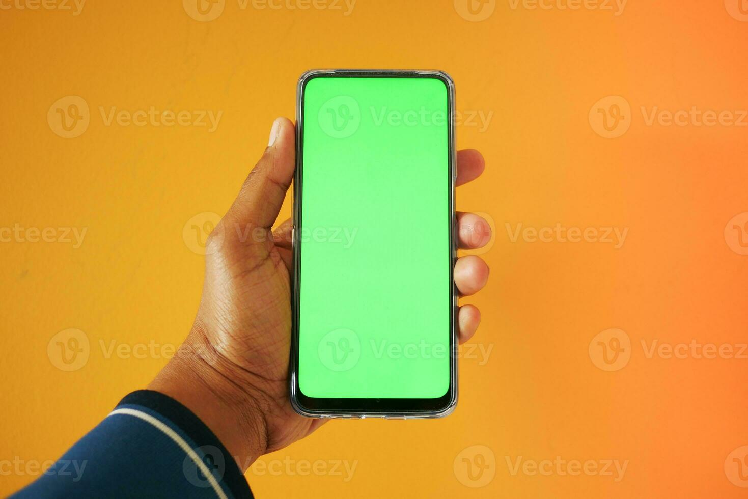 Close up of young man hand using smart phone with green screen photo