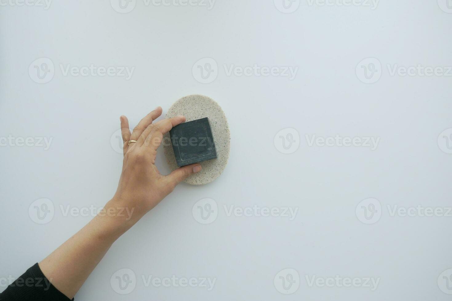 top view of women hand pick natural soap bar on white background photo