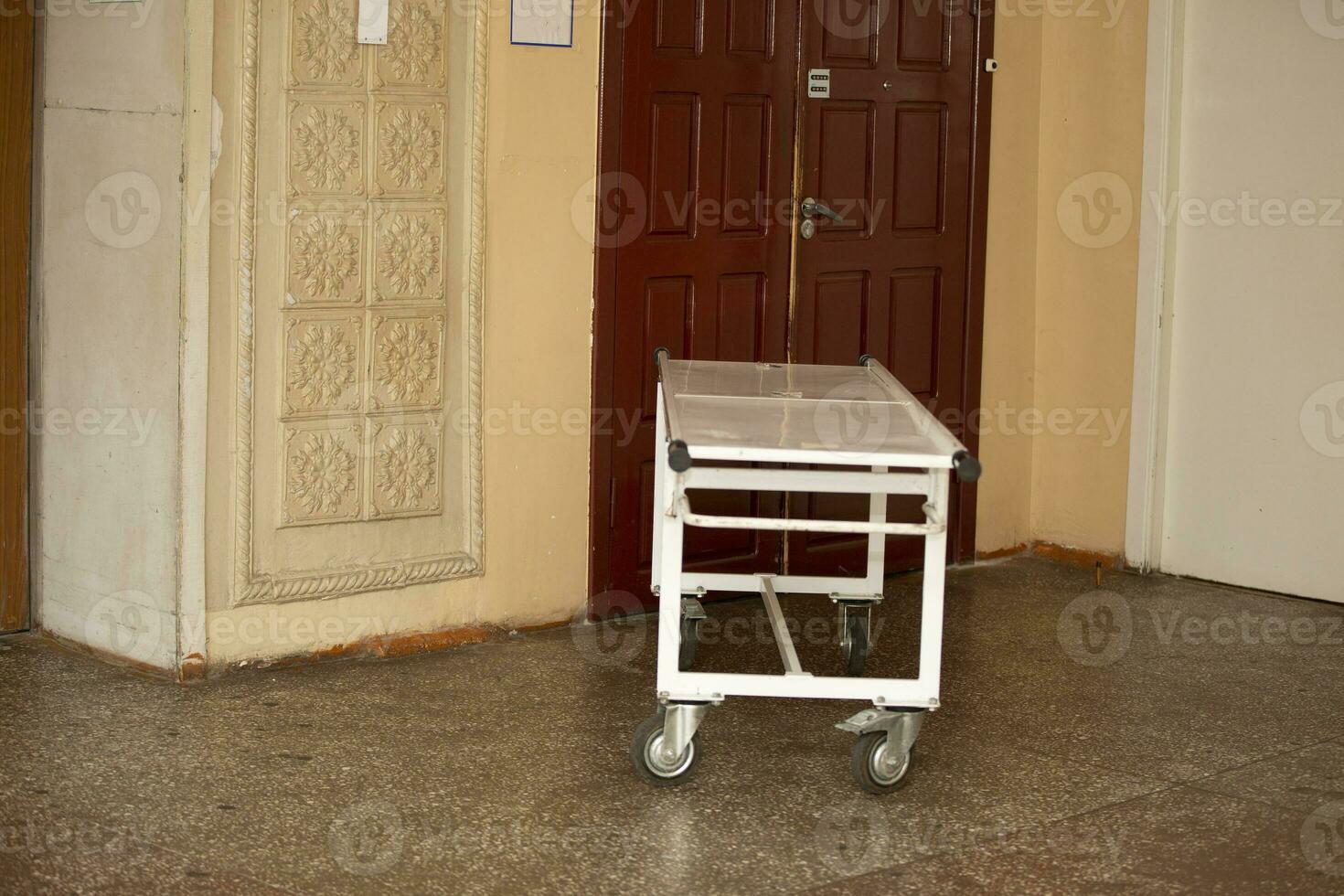 A hospital gurney stands in the corridor of the old hospital. photo