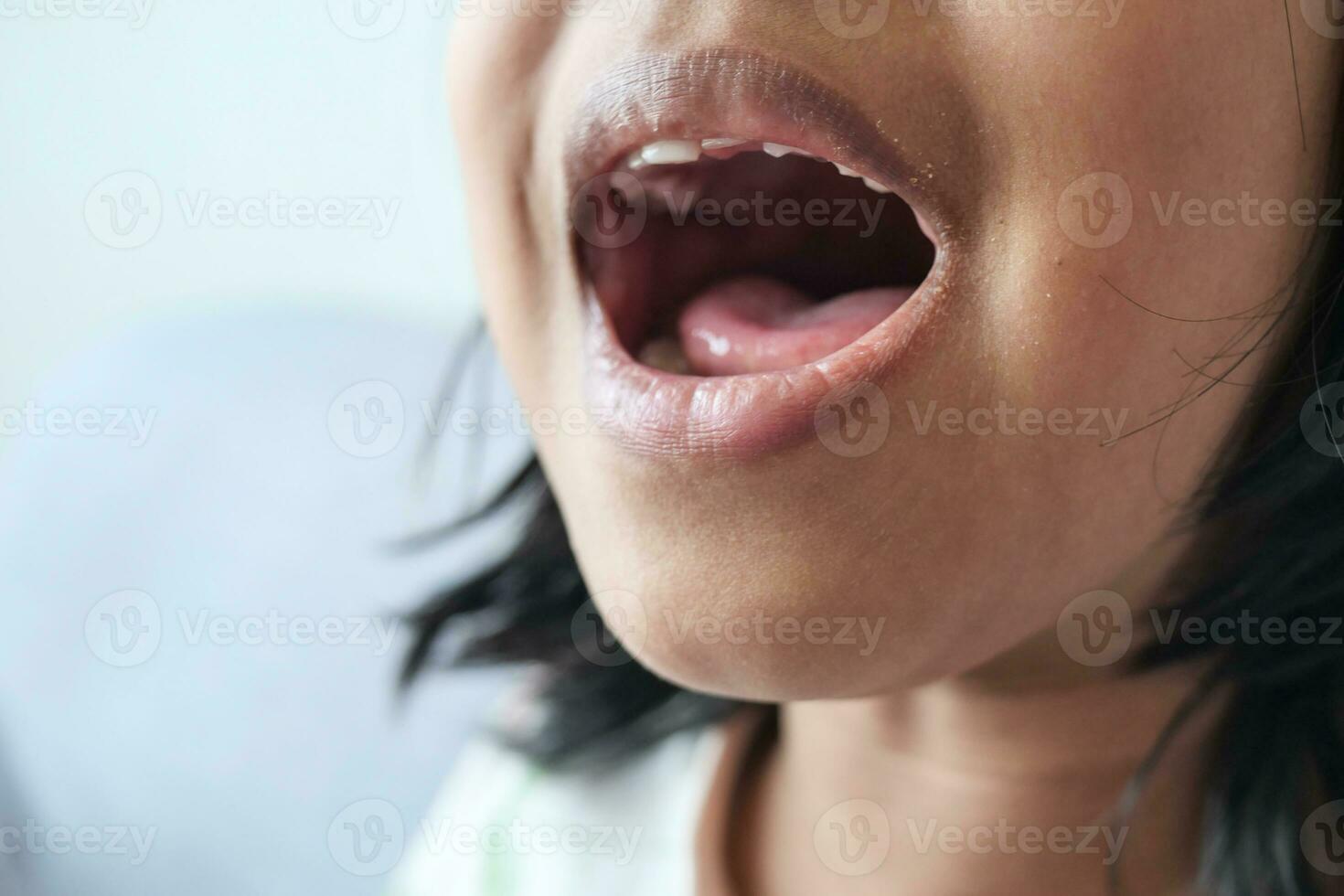 close up of child screaming at home photo