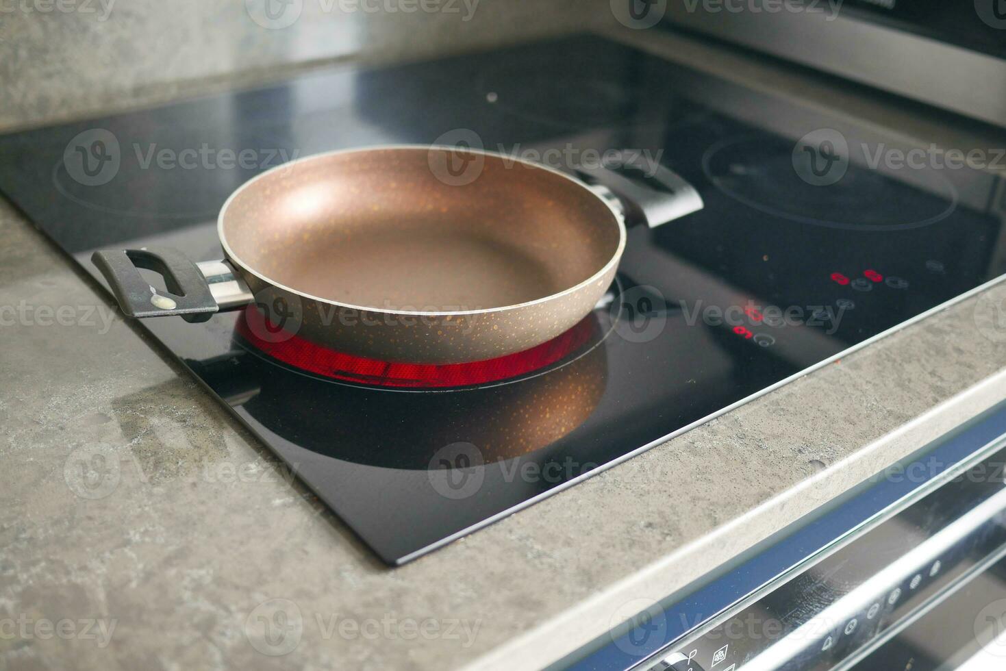 cooking pan on electric stove, electric stove is heated to red. photo