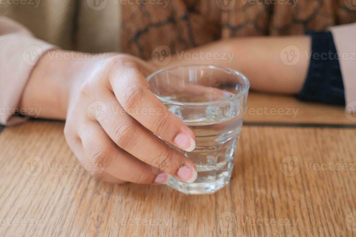 women holding a glass of water photo