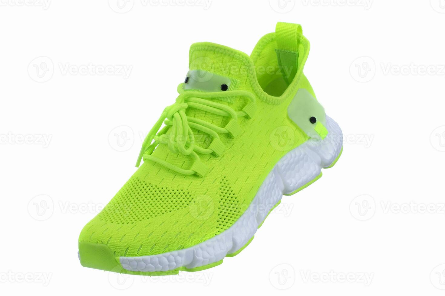 Green sneaker made of fabric with a white sole on a white shoe. photo