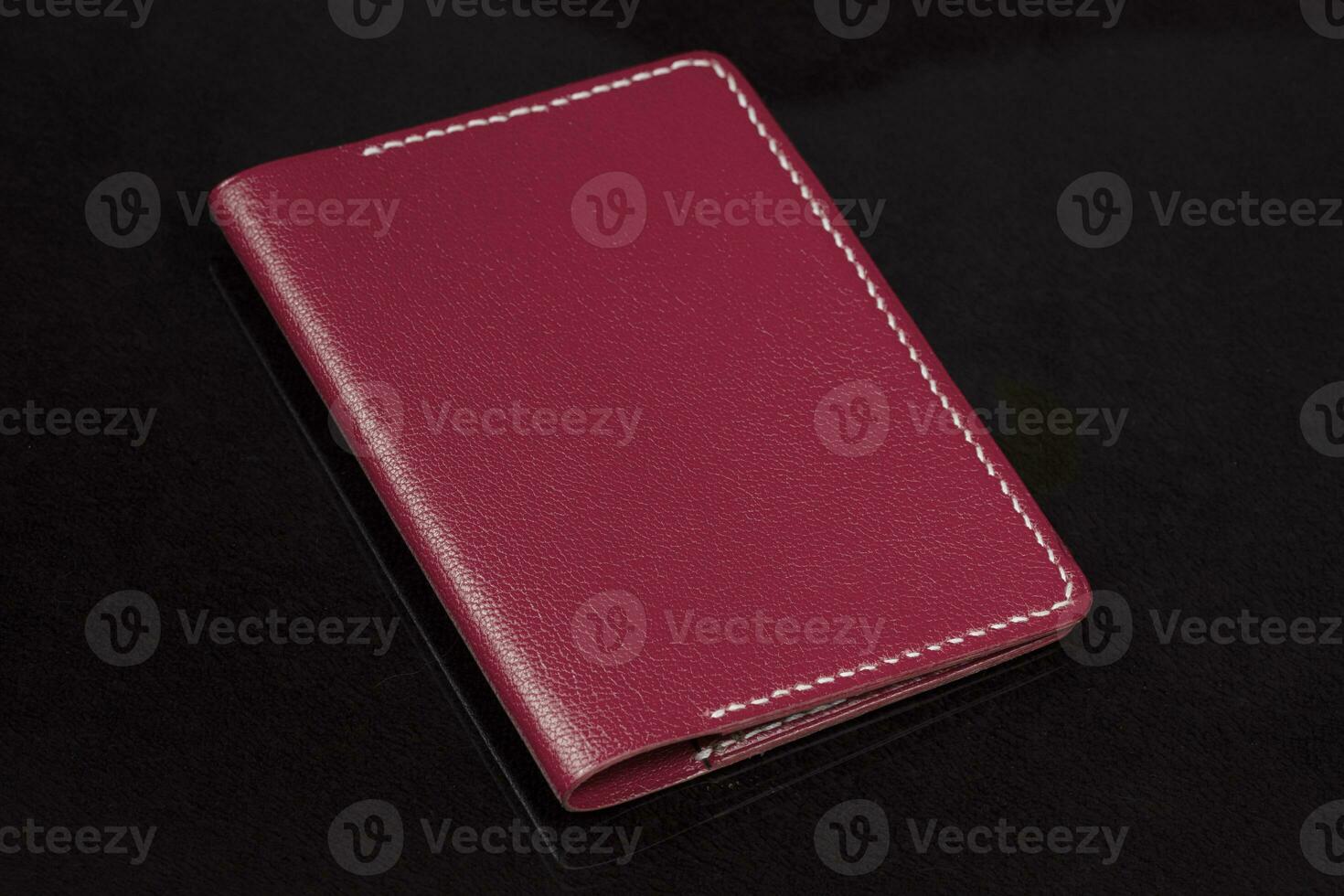 Leather wallet in red on a black background. photo