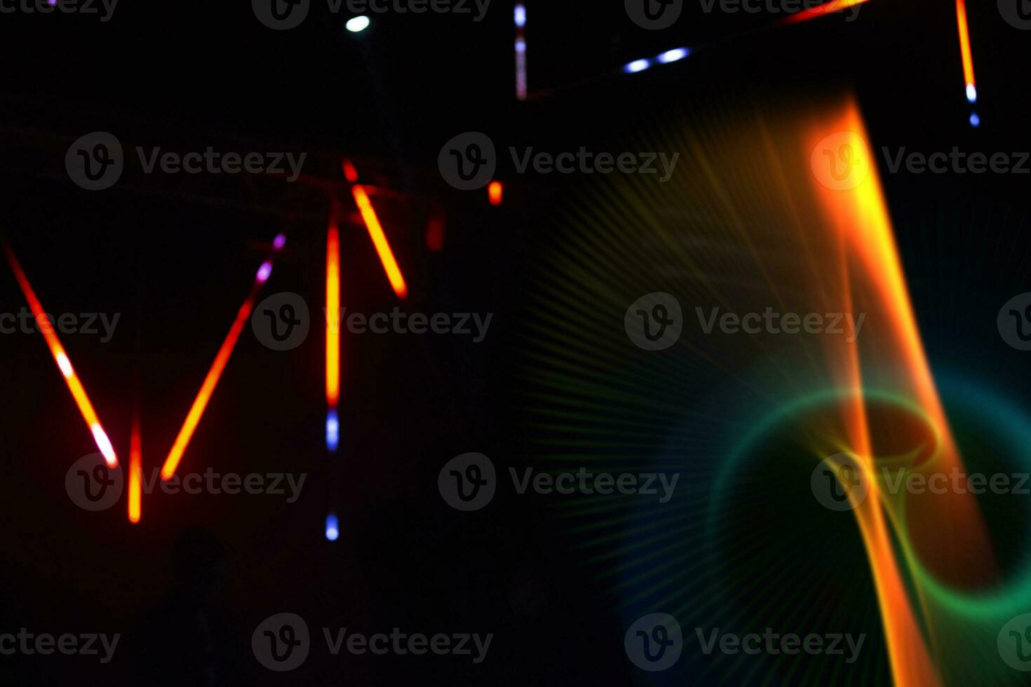Colored multicolored rays and swirls from the stage light on a dark background. photo