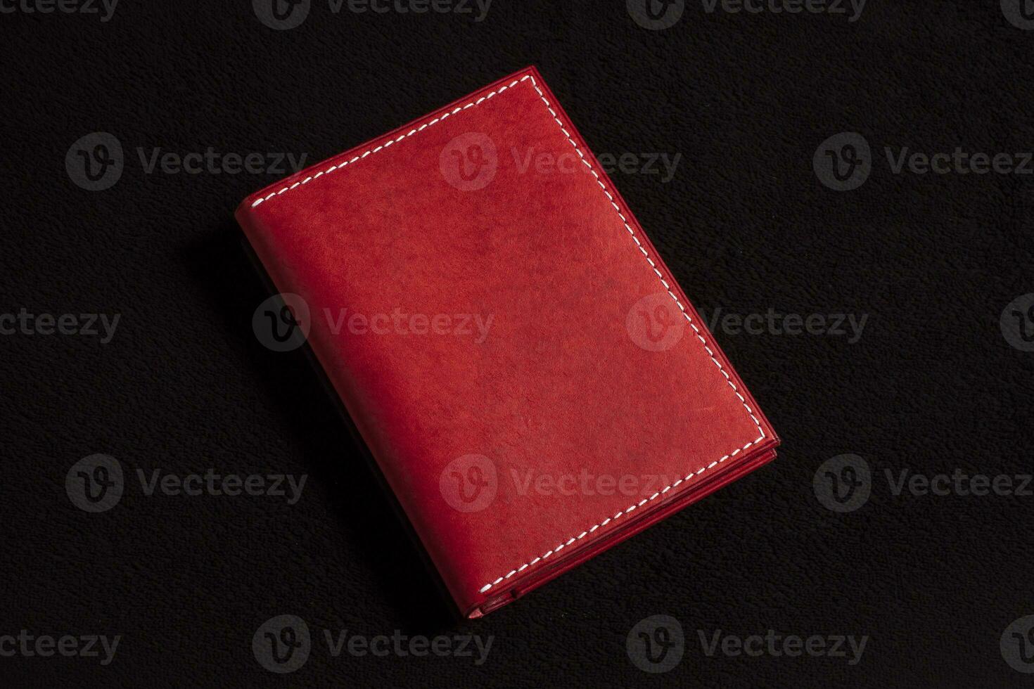cuero billetera rojo en un oscuro antecedentes. foto