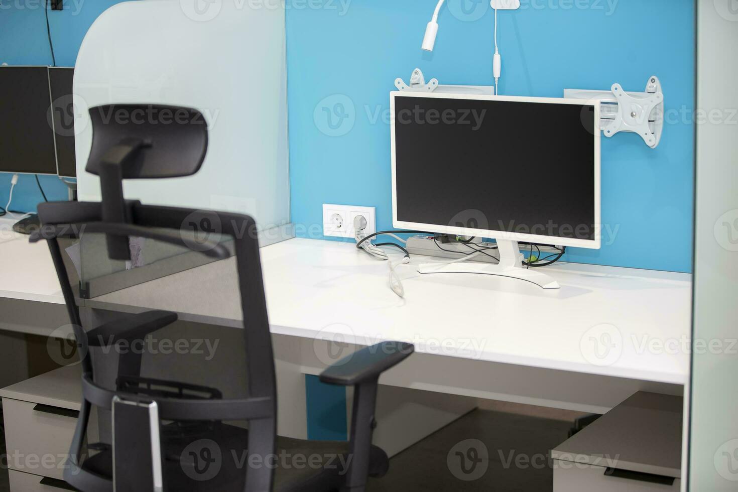 Workplace of a programmer or designer. There is a computer monitor on the table. photo