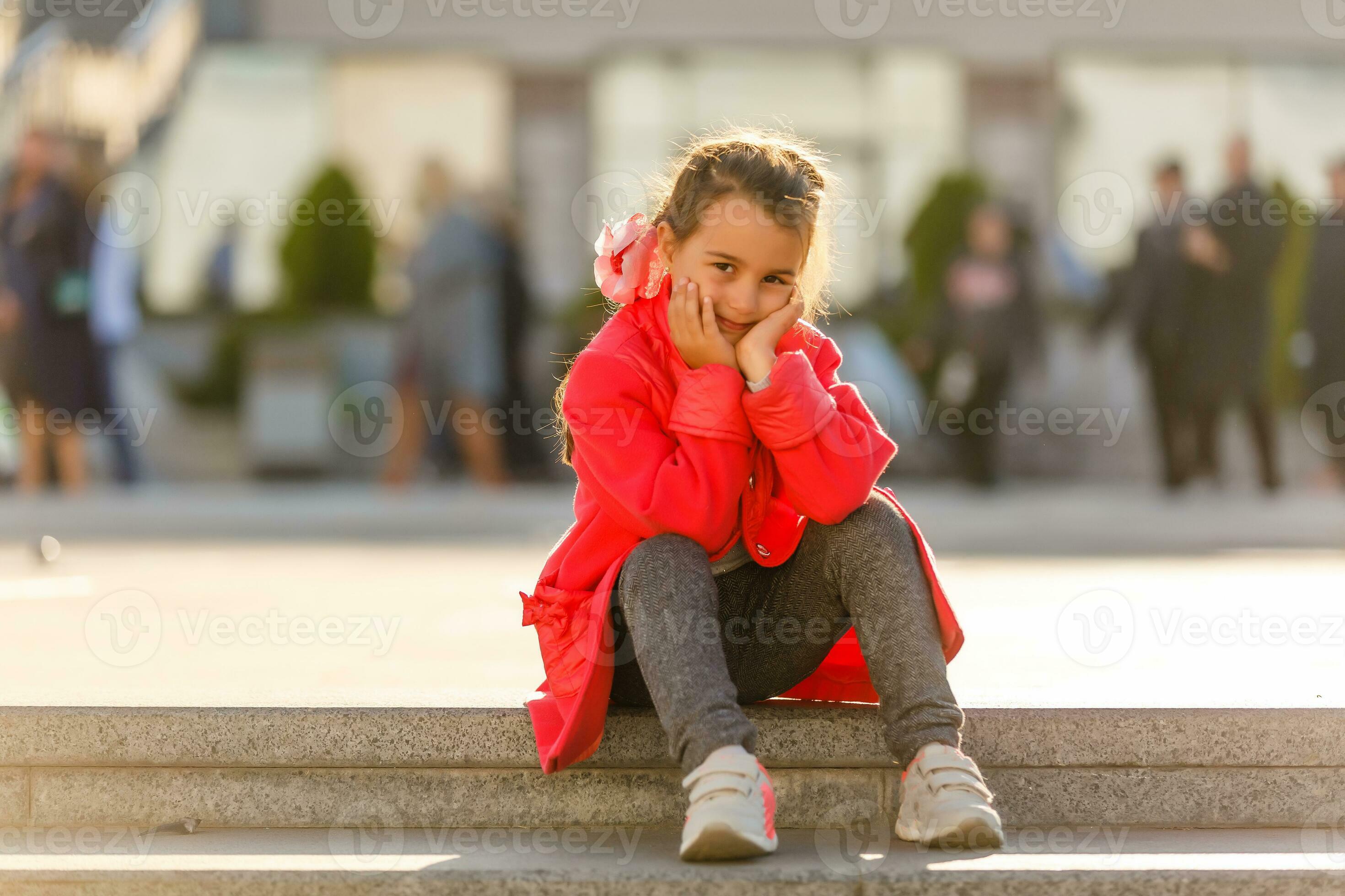 Cute little girl wearing red coat, grey leggings, and white sneakers.  Fashion concept 26461319 Stock Photo at Vecteezy