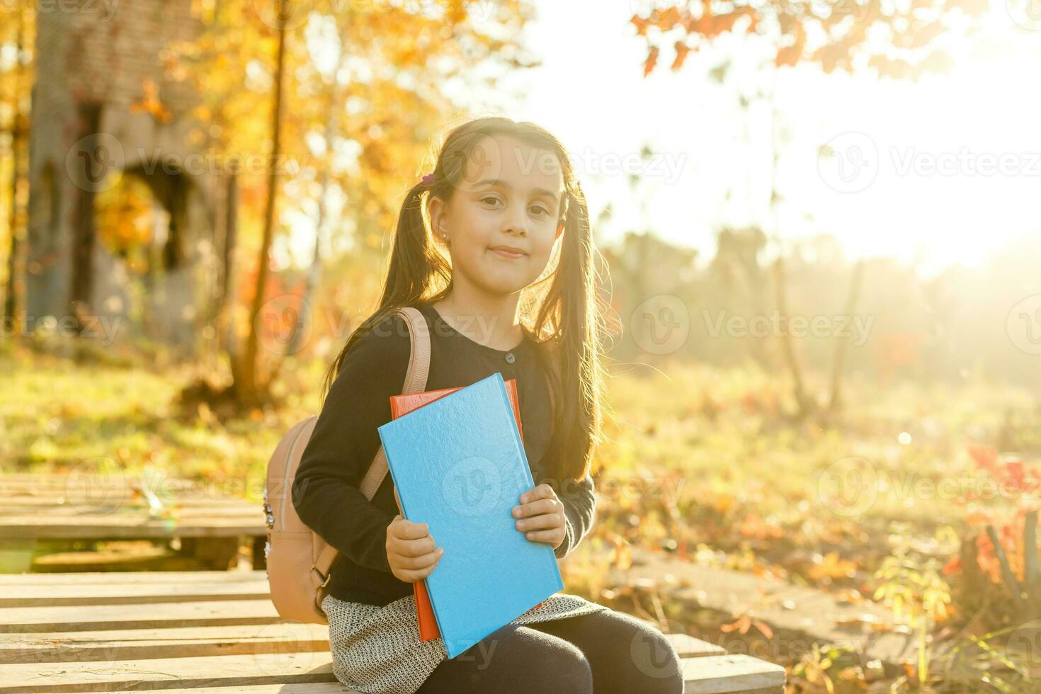 Keep studying. Little child enjoy learning in autumn park. Kid study with book. Small girl read book on autumn day. Autumn literature concept. Small child enjoy reading autumn foliage background. photo