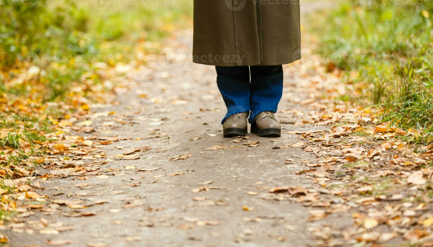 Woman walking cross country and trail in autumn forest photo