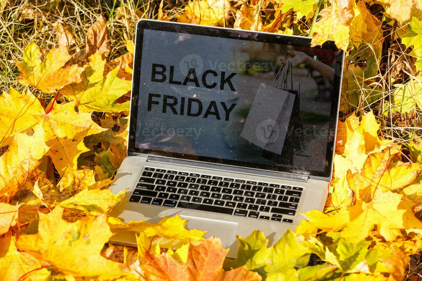 autumn sale, text in digital tablet with autumn foliage and rustic wooden planks background photo