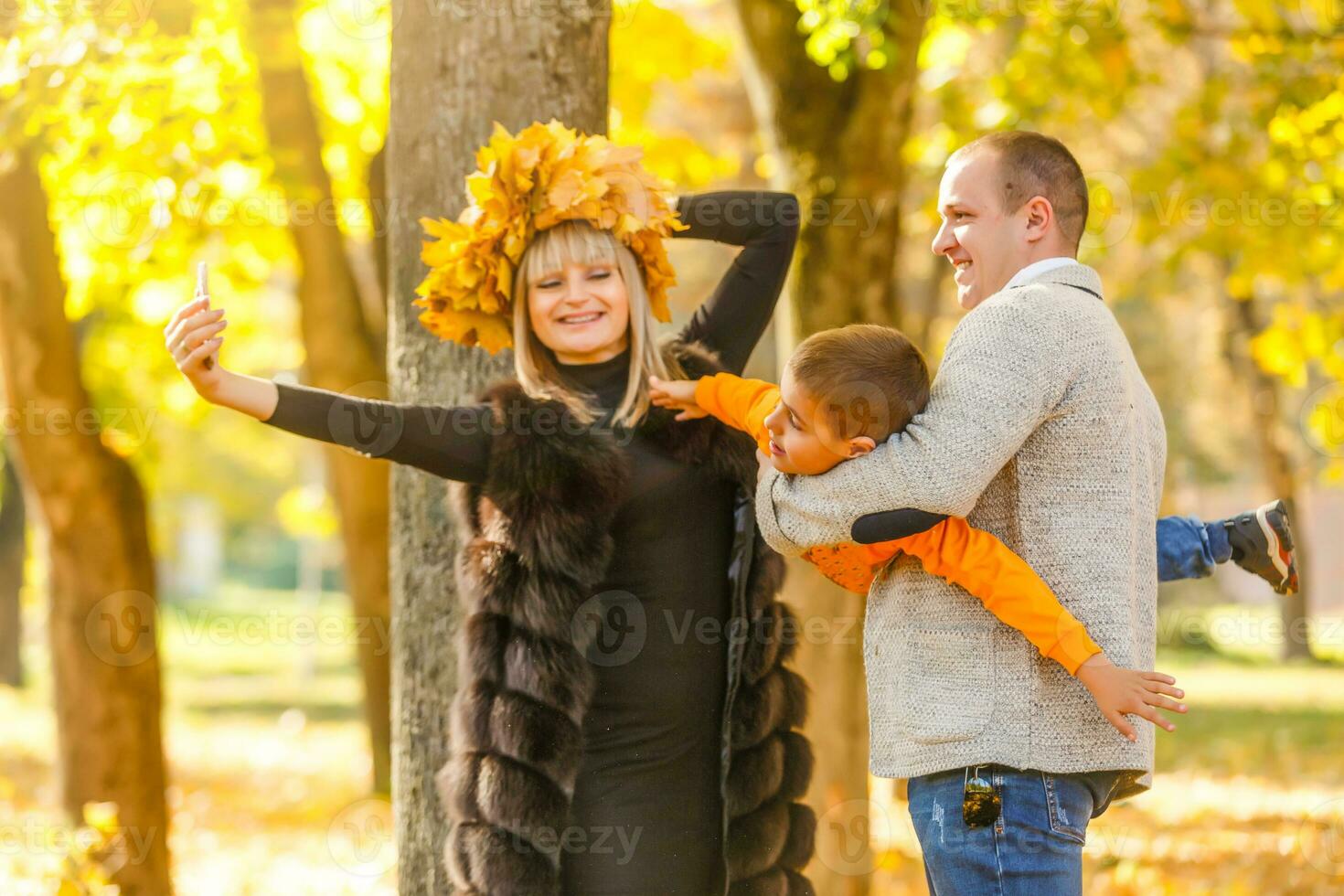 Family playing in autumn park having fun photo