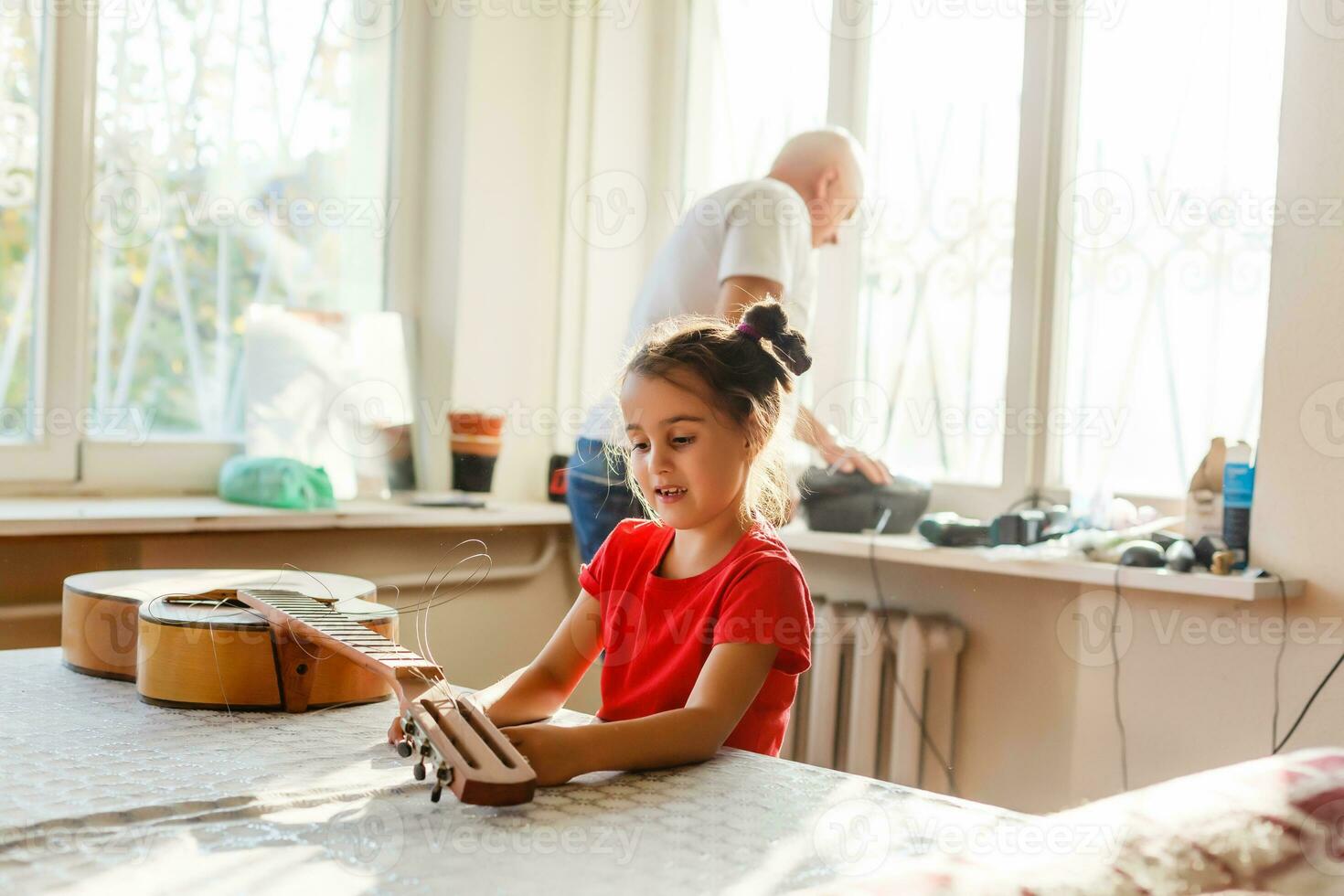 little girl holding a broken guitar, guitar repair photo