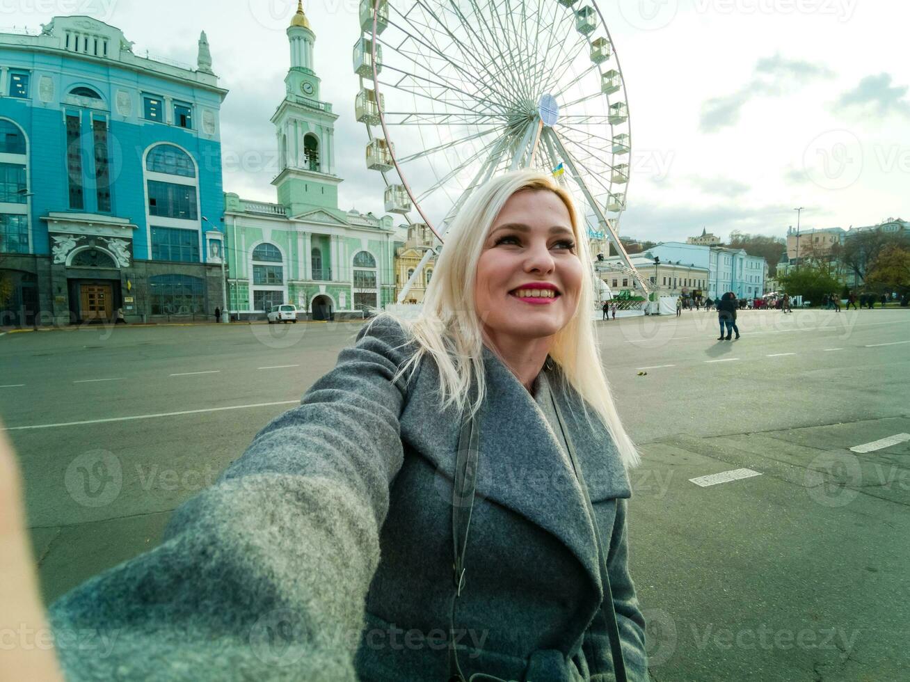 Stylish woman posing near ferris wheel photo