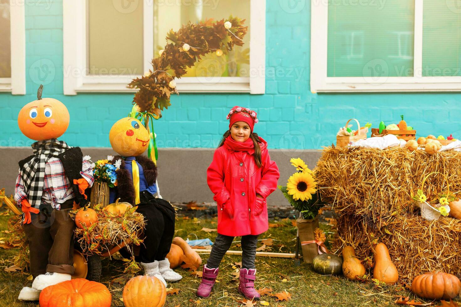 Cute little girl in a pumpkin patch photo