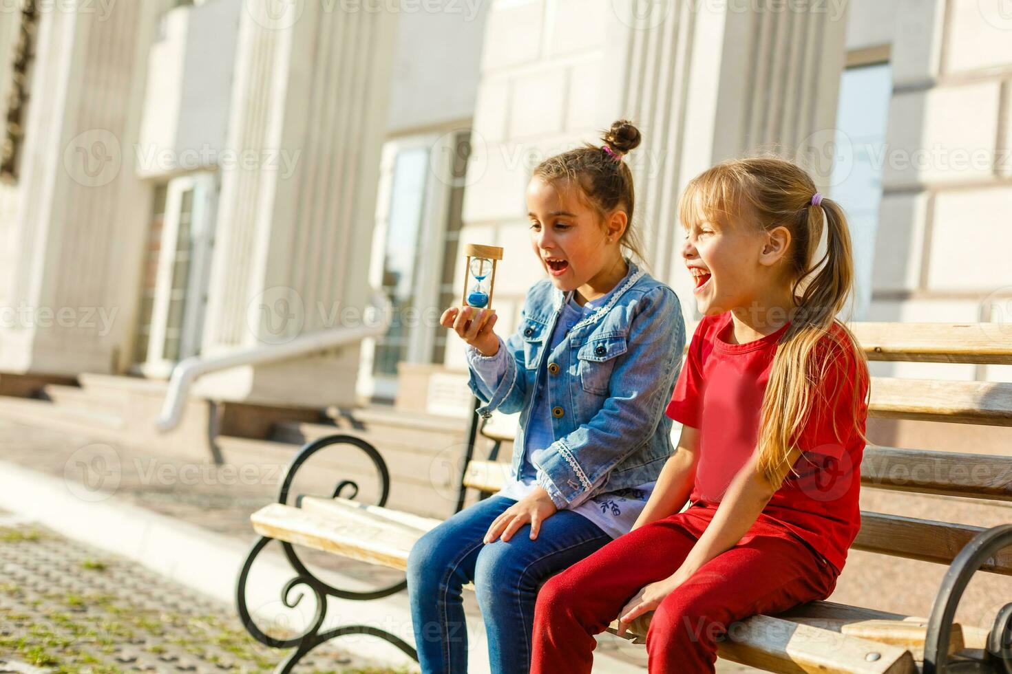 two little girls play hourglass photo