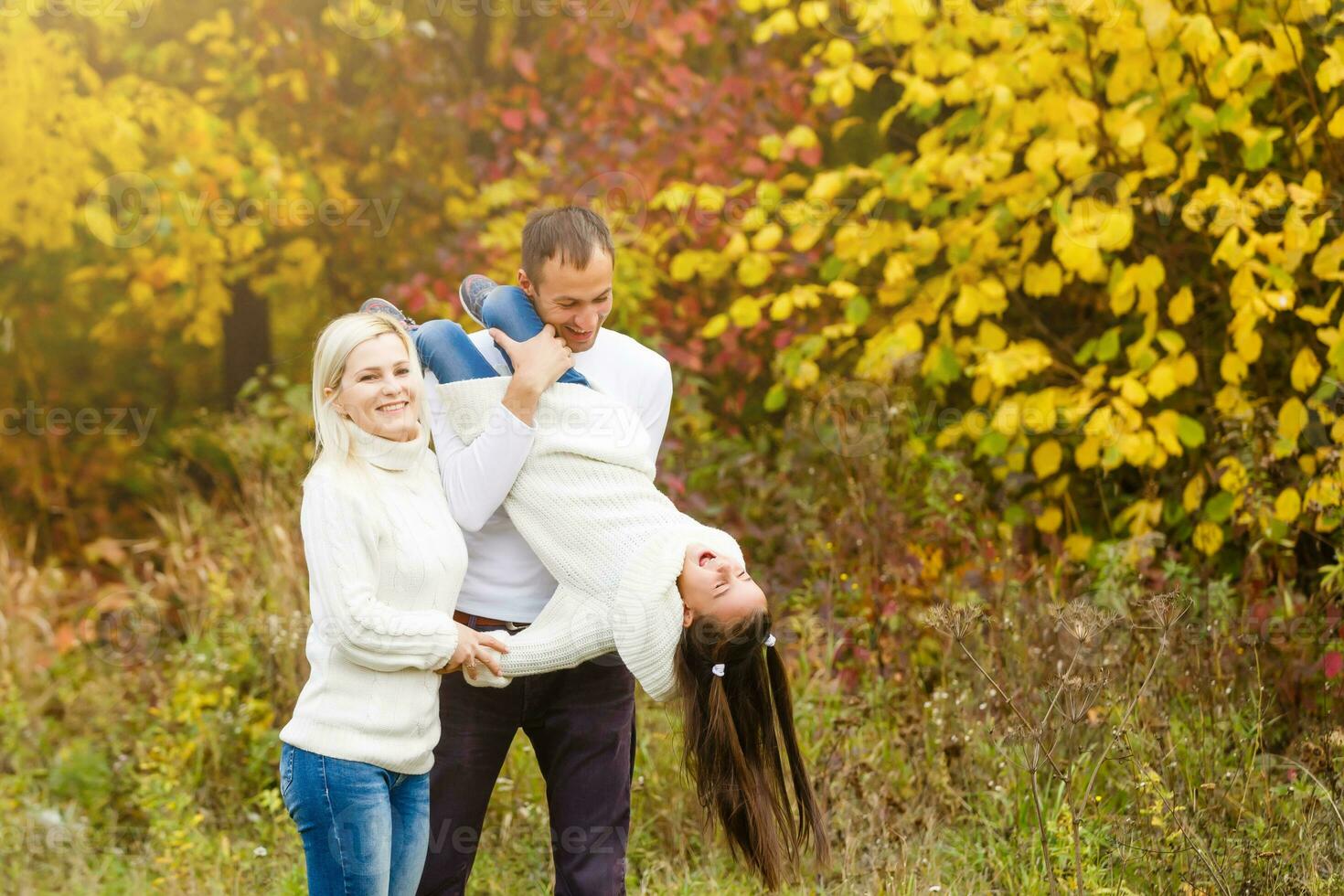 Family with child go in autumn park photo