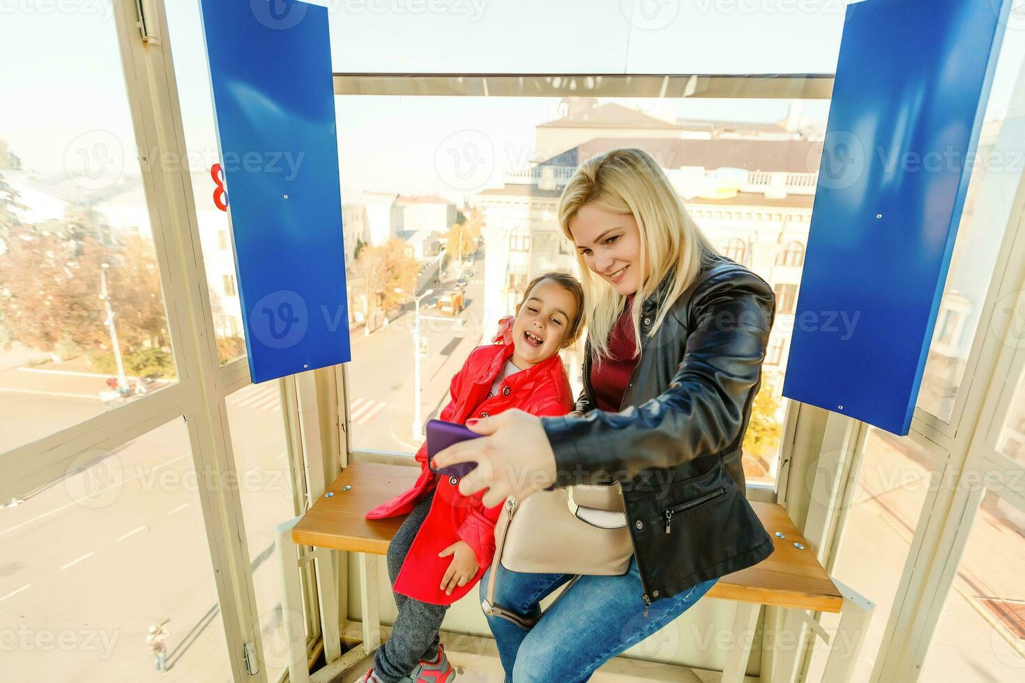 Portrait of happy mother and baby talking in big ferris wheel.Relationship concept. photo