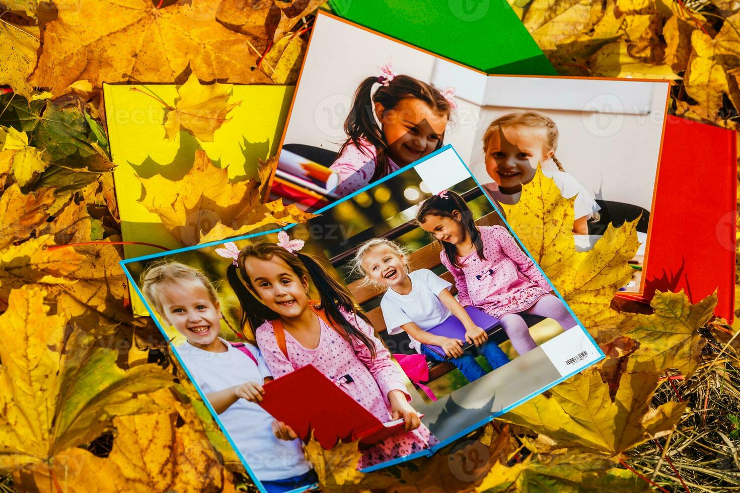 school photo book on the yellow leaves top view. rustick photo of autumn composition