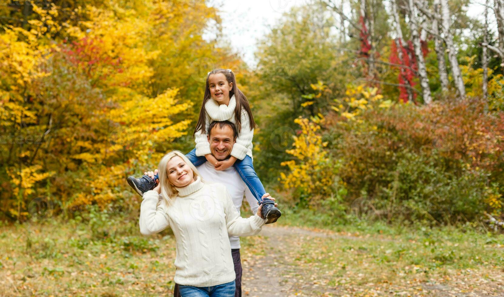 family, childhood, season and people concept - happy family in autumn park photo