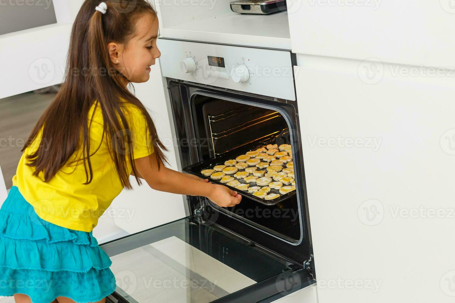 Little girl make cookies at the advent time. photo