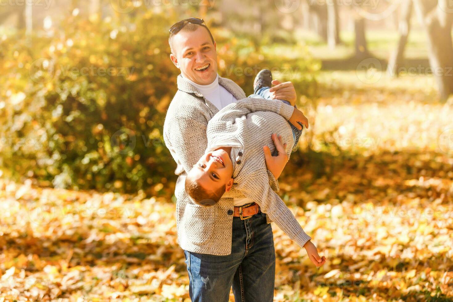 dad and son on a autumn park background photo