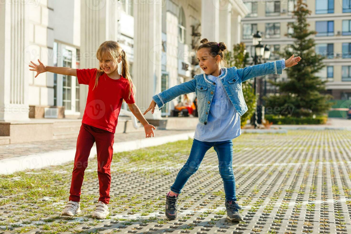 Portrait of happy fashion little girls having fun in the city photo