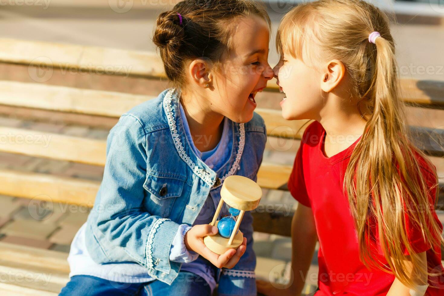 two little girls play hourglass photo