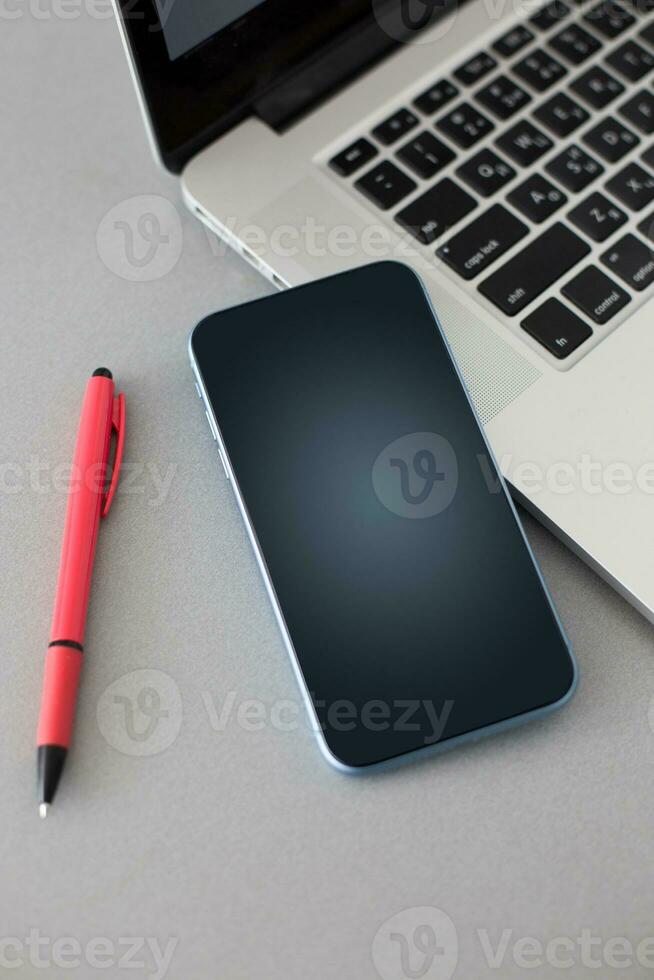 smartphone with black banner on the screen lies on desk. Application on screen created in graphic program photo