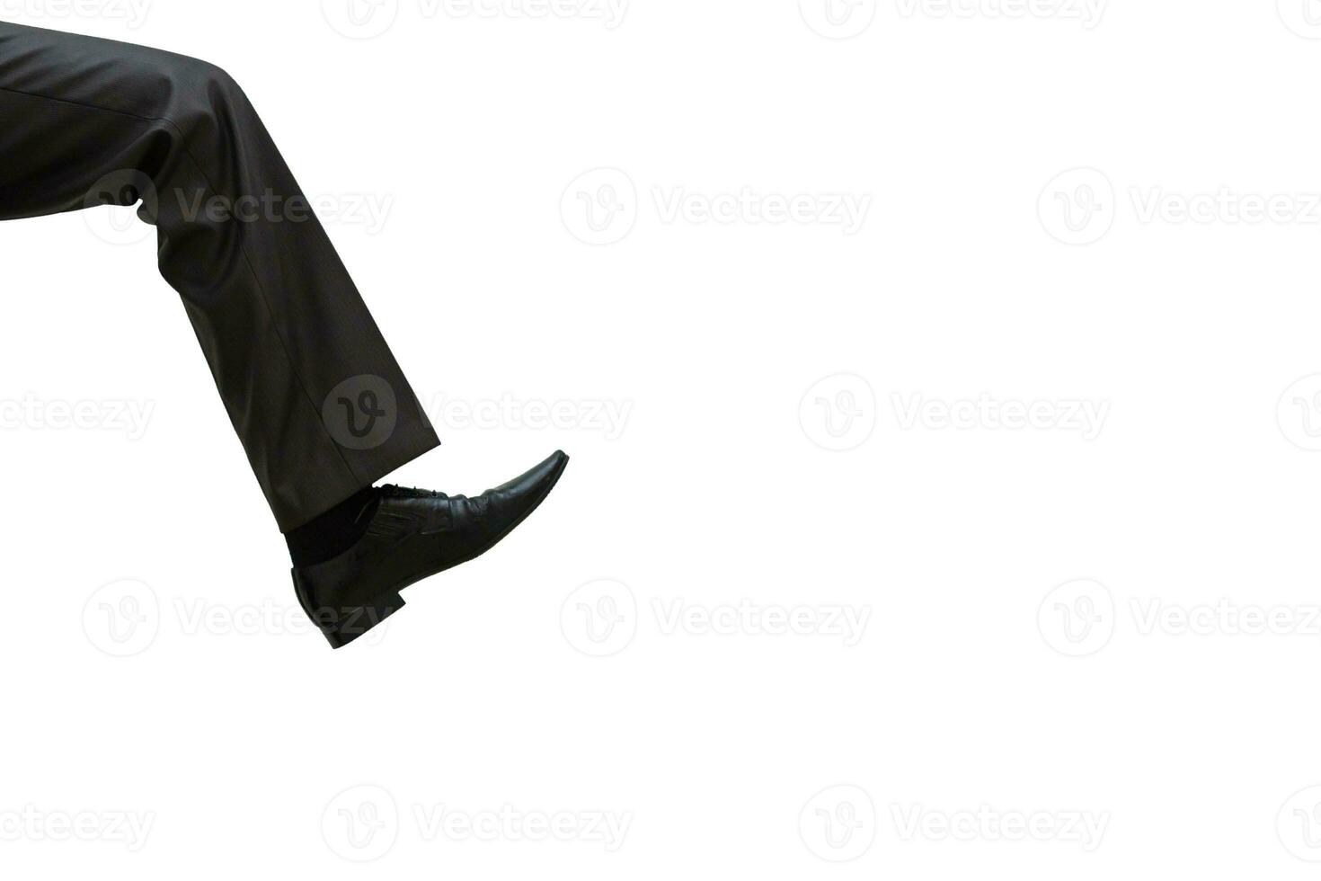 A huge human foot close up isolated on white background. A big businessman leg in trousers and shoes comes on copy space. photo