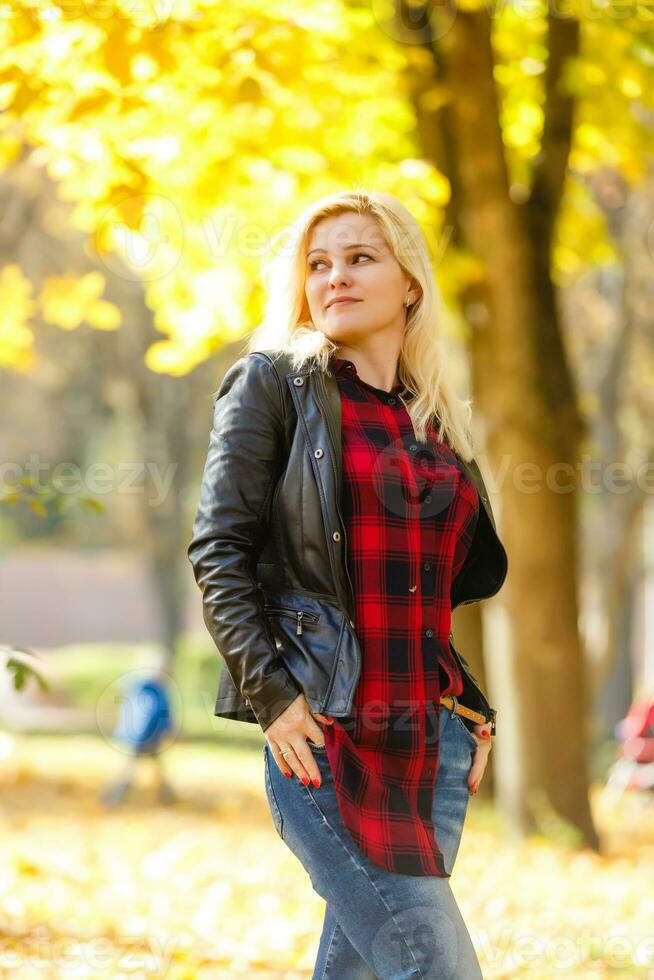 girl walks in the autumn park photo