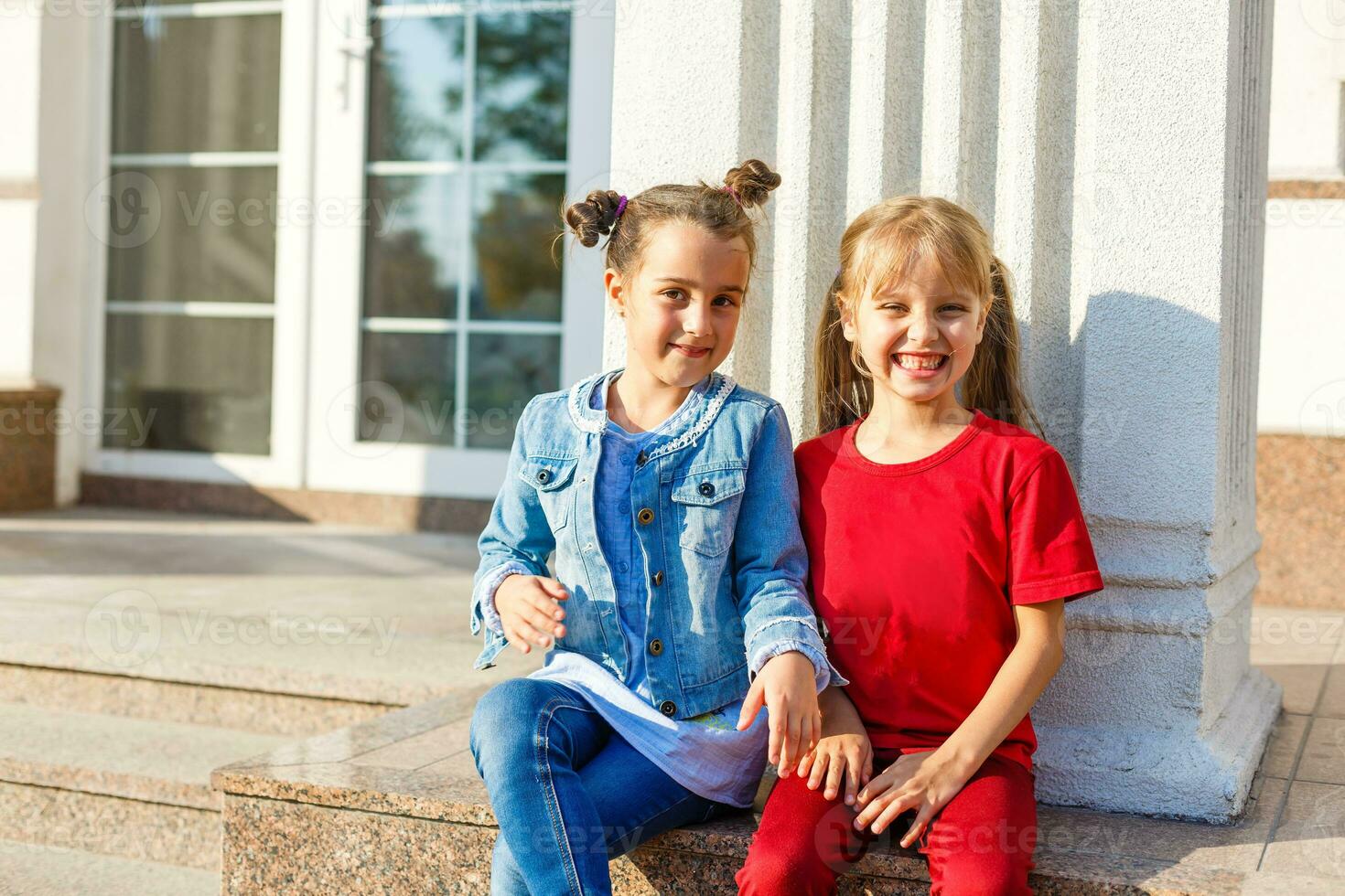 Portrait of happy fashion little girls having fun in the city photo