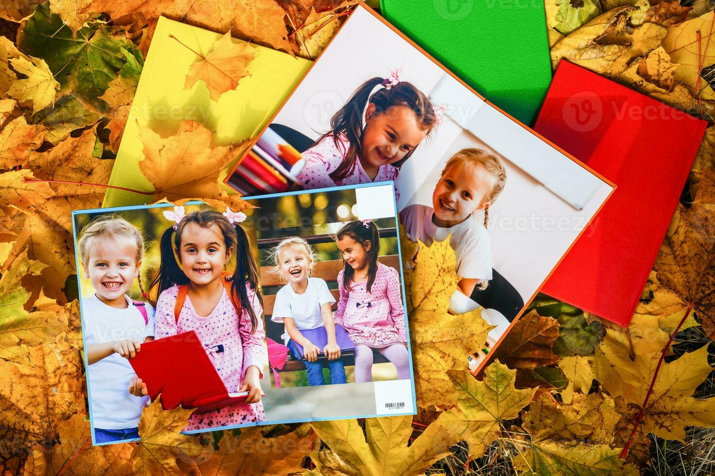 school photo book on the yellow leaves top view. rustick photo of autumn composition