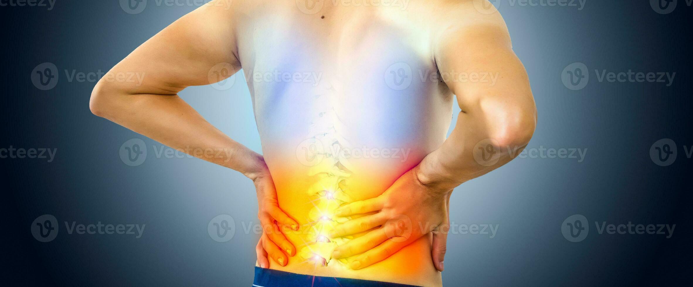 Lower back pain. Man holding his back in pain. Medical concept. photo