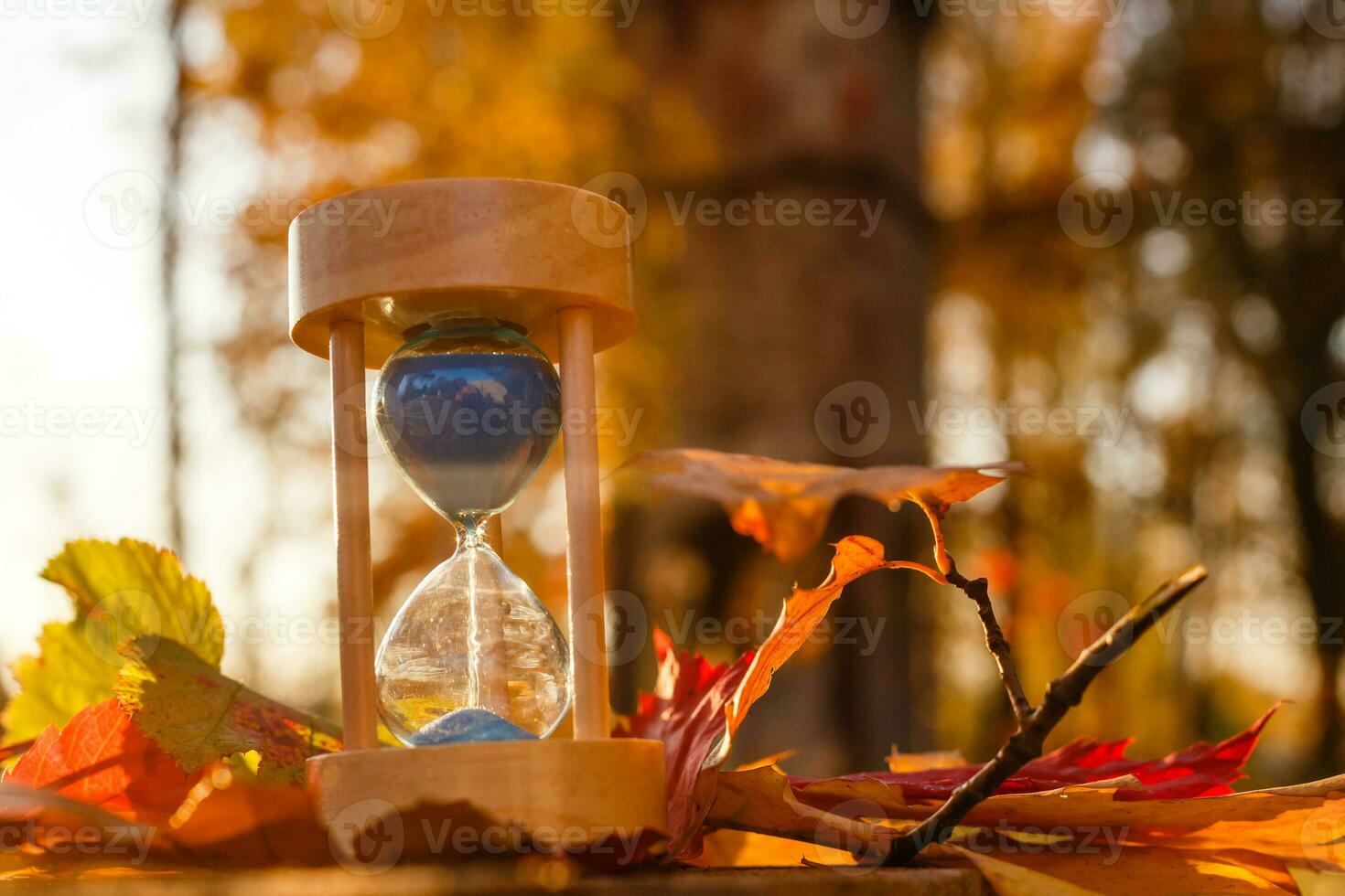 Clock, Hourglasses and Autumn Leaves photo