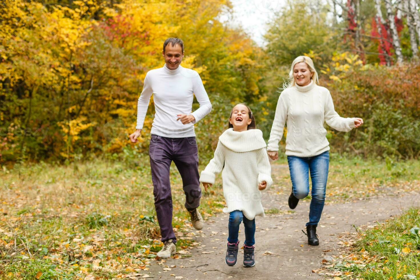 family, childhood, season and people concept - happy family in autumn park photo